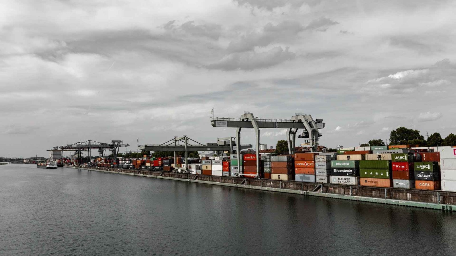 Container port with cranes loading cargo vessels